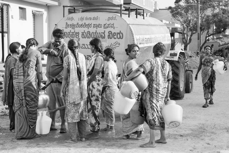 Buying potable water from a tanker in a salinity and fluoride-affected suburb of Kolar city, Karnataka